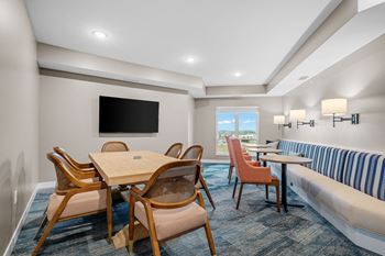 a living room with a table and chairs and a couch